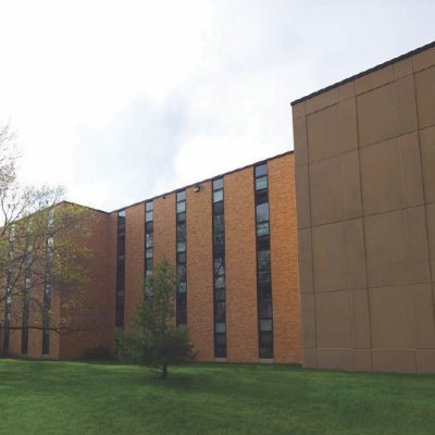 Mathews Hall on a green grass lawn