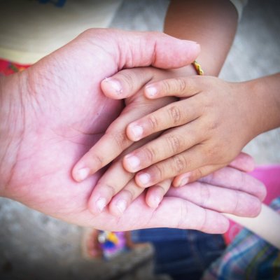 Adult holding Child's hands