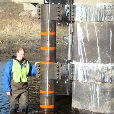 Researcher standing by ice load sampler