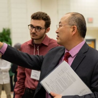 Man pointing at research poster