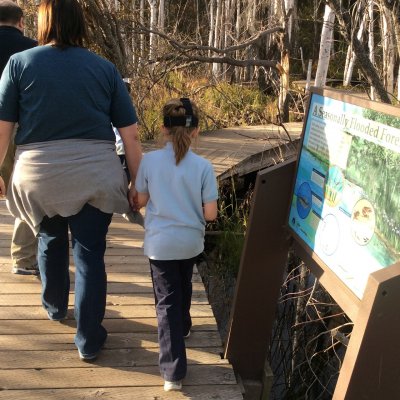 Student and teacher walking in the park