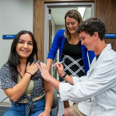 A pharmacy student learns how to give a vaccination.