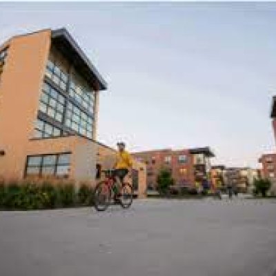 Student riding a bike through Jackrabbit Village