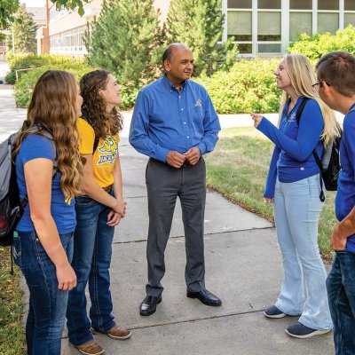 Vikram Mistry visits with students outdoors on the South Dakota State University campus.