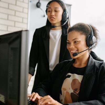 Two Women With Headsets Working As Call Center Agents