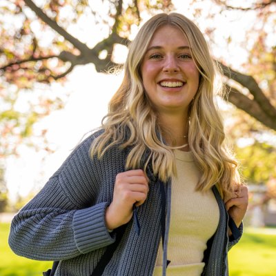 Young woman standing and smiling at camera.