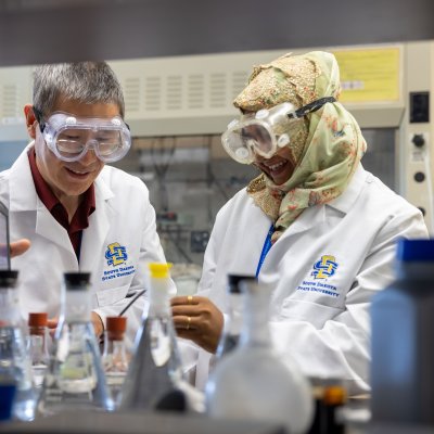 Instructor and student working in a chemistry lab.