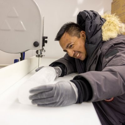 Student working with ice in a chemistry lab.