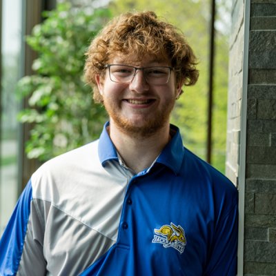 College student smiling at camera.