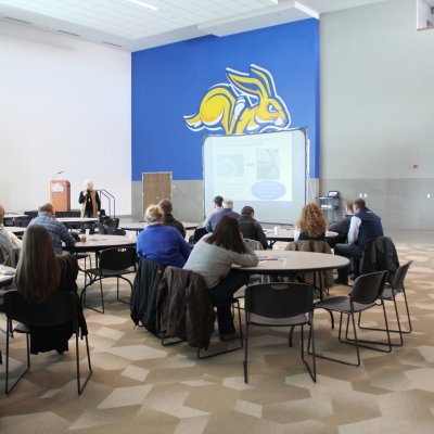 A group listens to a presentation.