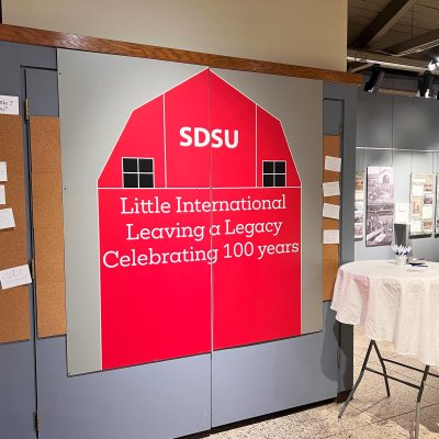 SDSU Little International Leaving a Legacy Celebrating 100 Years printed in white on a red barn outline