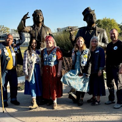 OMAA staff members dress in Hobo gear standing in front of the Weary Wil and Dirty Lil statues at SDSU