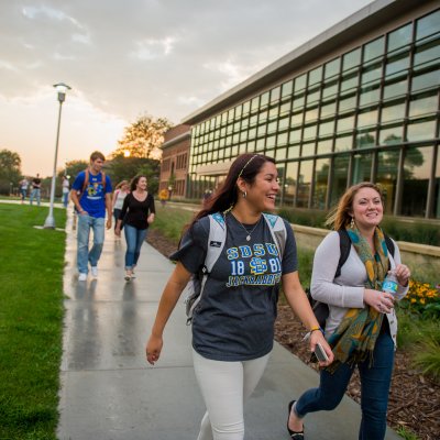 Students walking by the AME building.