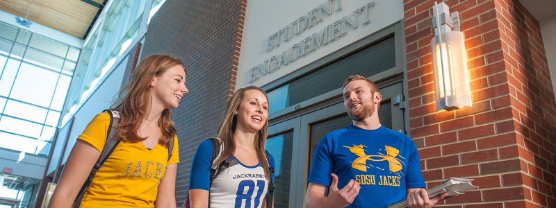 Students walking in front of Student Engagement Office