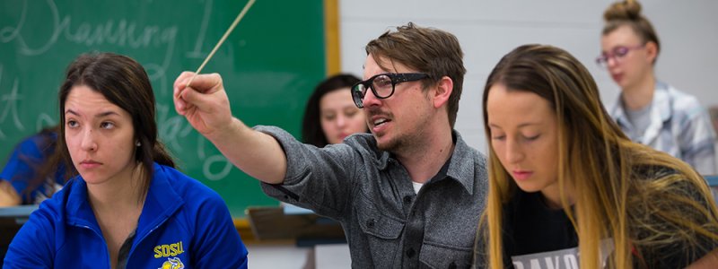 A professor works with two students