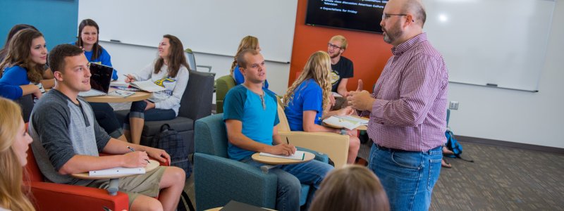 Professor teaching in a classroom full of students 