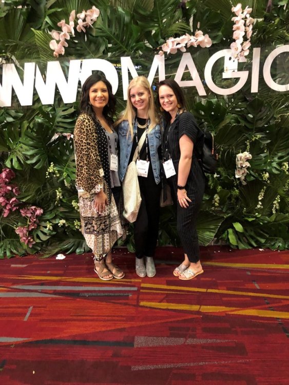 Students posing in front of Magic Market sign