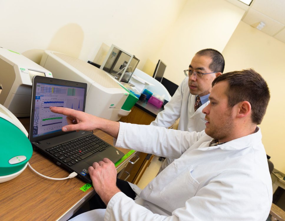 Faculty and student using lab equipment