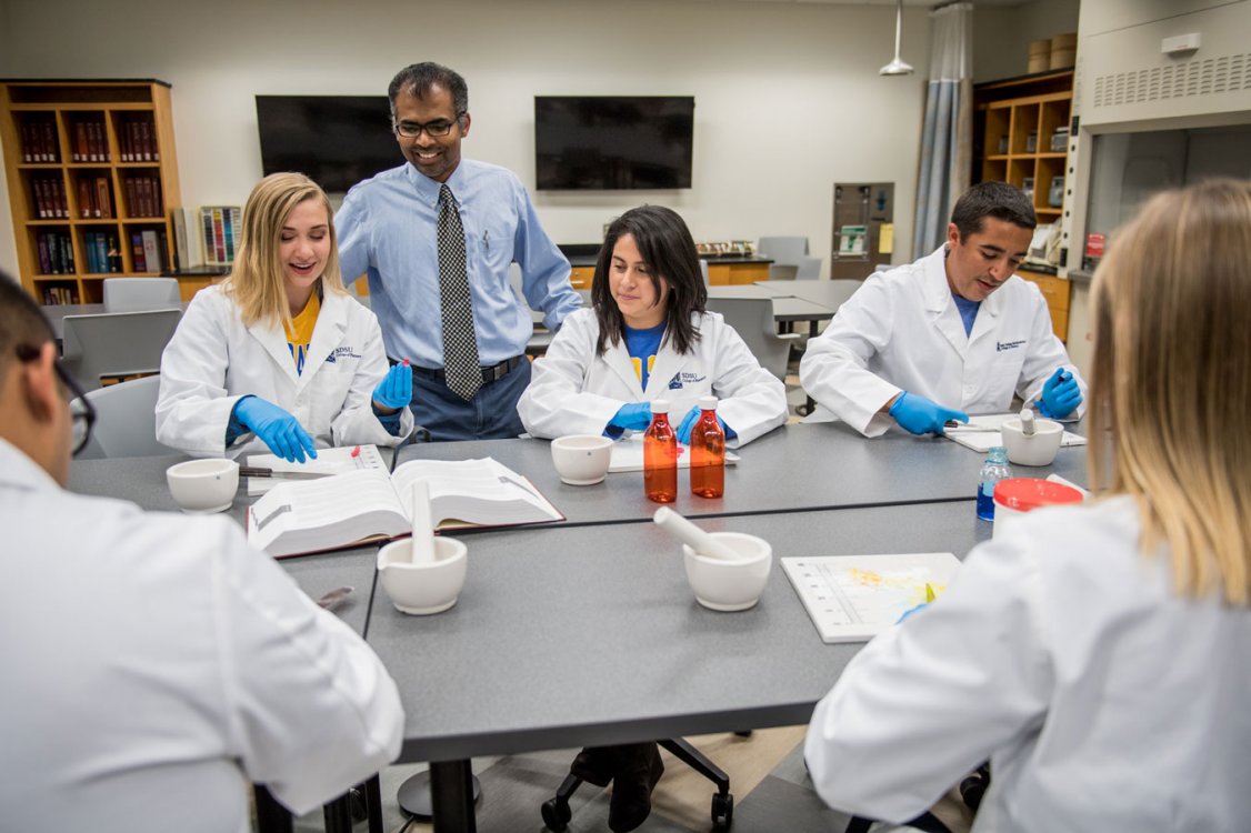 Faculty teaching students how to compound medication