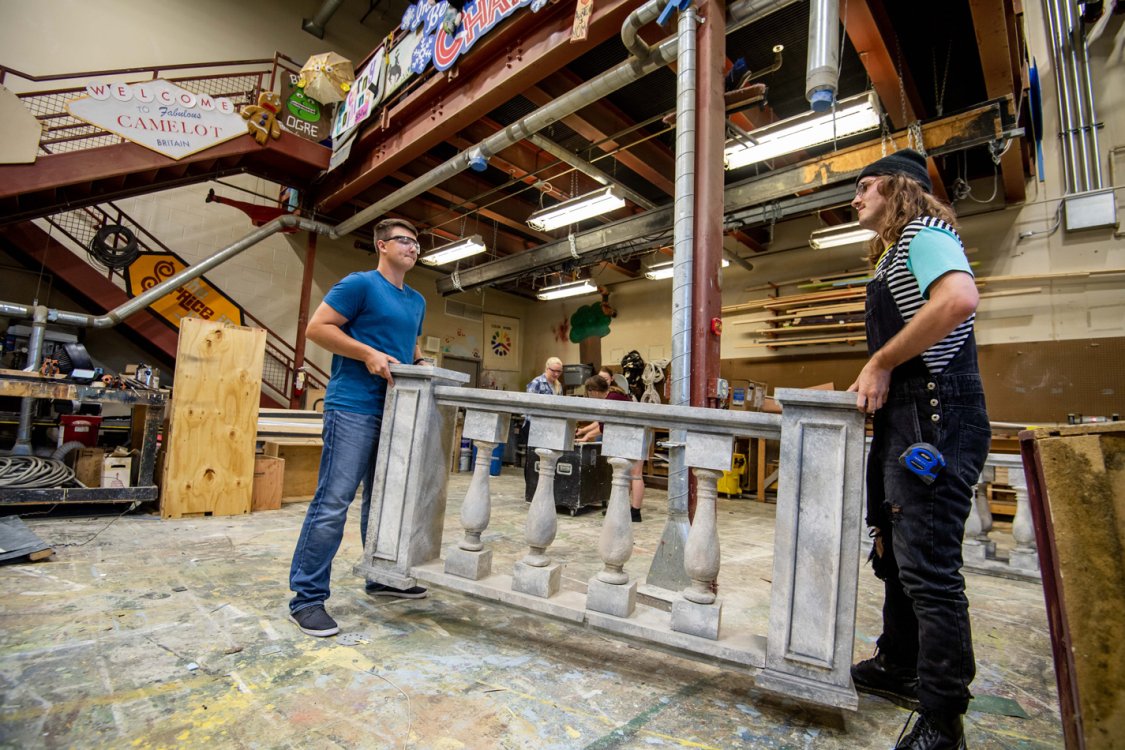 Two theatre students working in the scene shop.