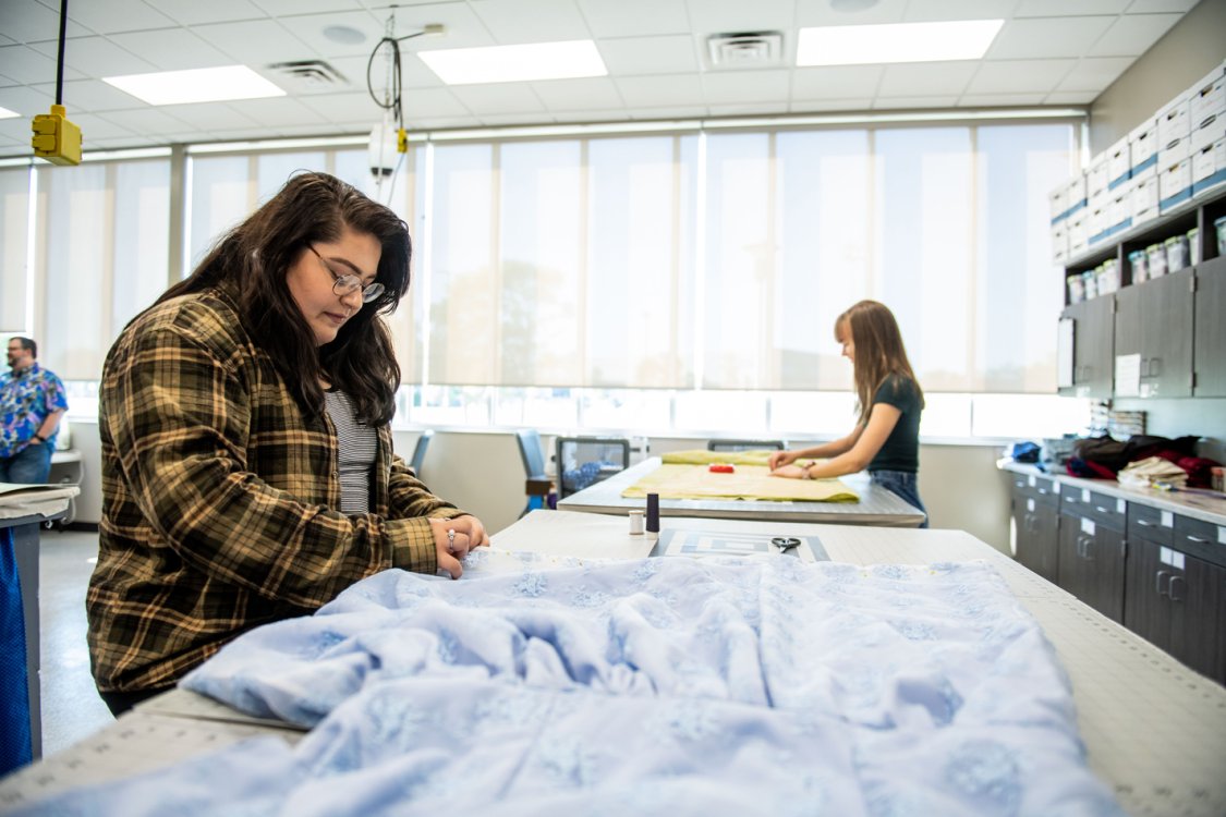 Cutting fabric in the costume shop.