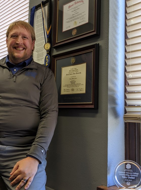 Toby Ueker Poses in Office