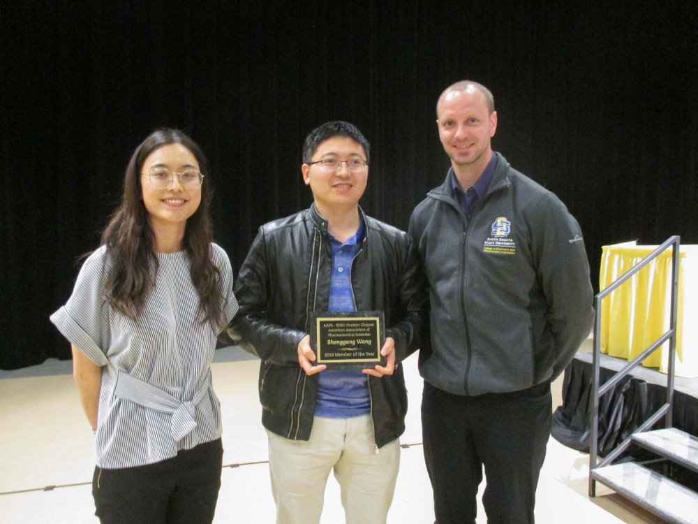 Students and Professor at an award ceremony 