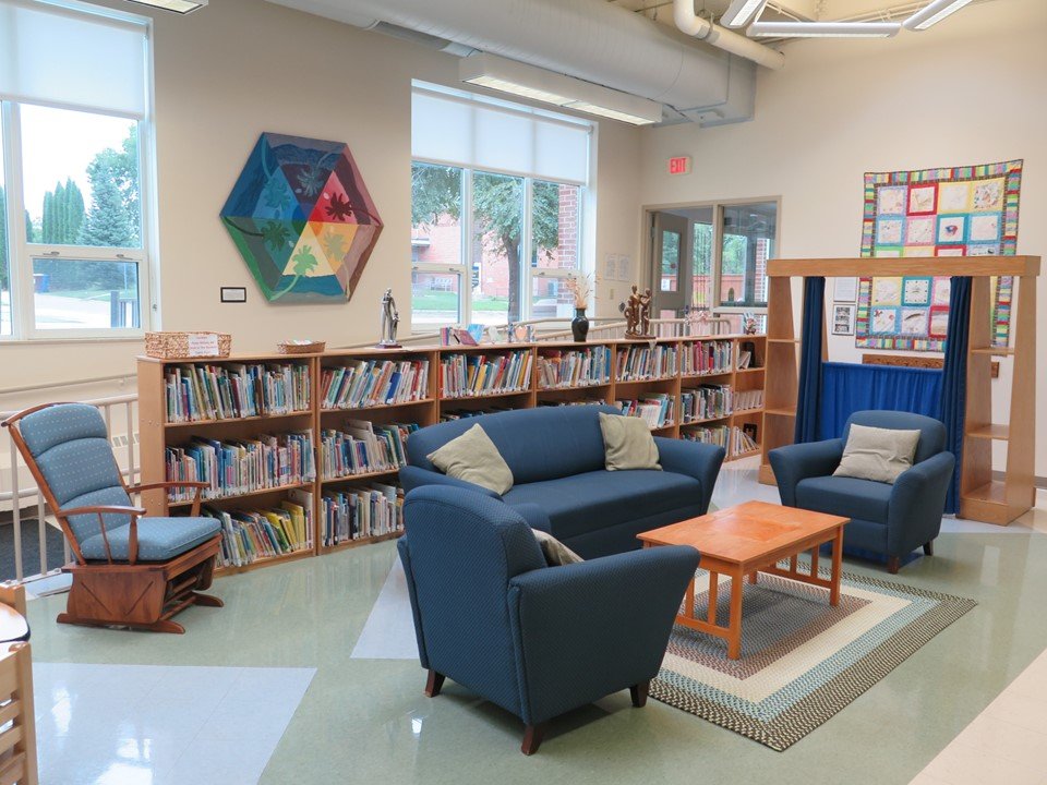 The gathering space that includes the mini library and a puppet show stand.