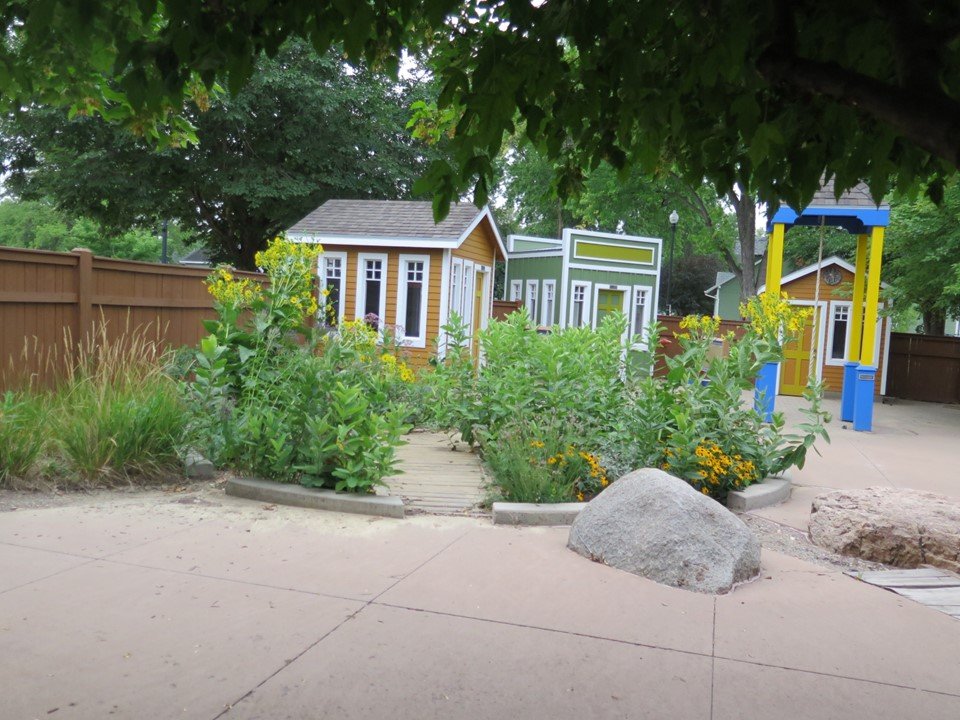 View of the playground with the gardens and houses in the background.