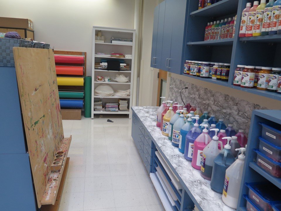 Easels and different types of paint in the art studio.