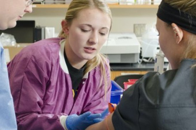 Student drawing blood in lab