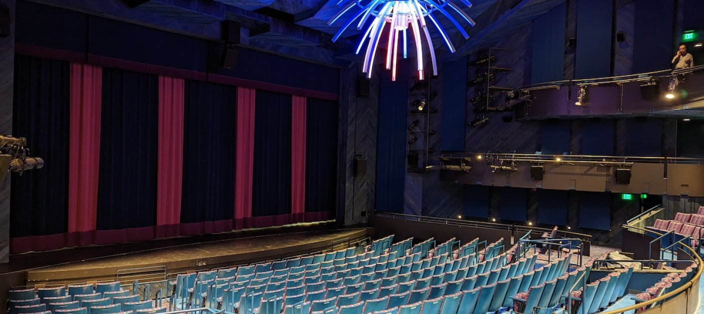 Multicolored chandelier inside a performance space