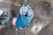 Blue chalk bag on a rock wall