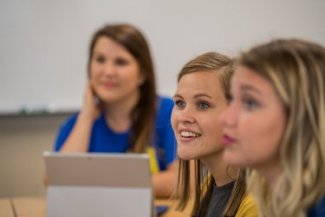 Students looking up and listening in counseling course.