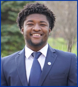 Student's Association Jerome J. Lohr College of Engineering senator Moises Dereconfort sitting on a bench outside smiling